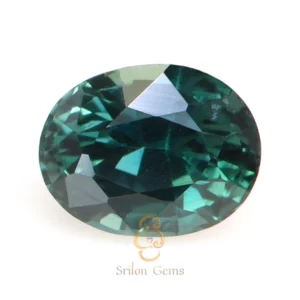 Natural 0.83 carat oval teal sapphire from Madagascar with intense teal color, mixed brilliant cut, and excellent polish displayed on white background by Srilon Gems.