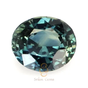Natural bluish green oval sapphire gemstone with intense color saturation and brilliant mixed cut displayed against a neutral background.